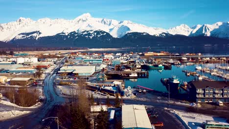 4K-Drone-Video-of-Seward-Boat-Harbor-and-Surrounding-Snow-Covered-Mountains-on-Snowy-Winter-Day-in-Alaska