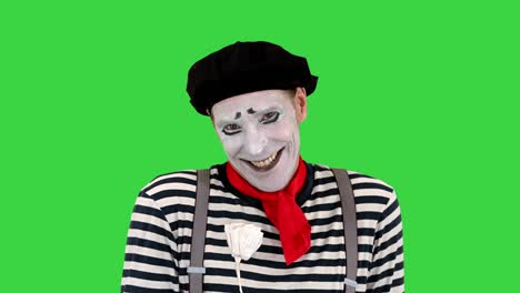 mime giving a paper rose to camera on a green screen, chroma key