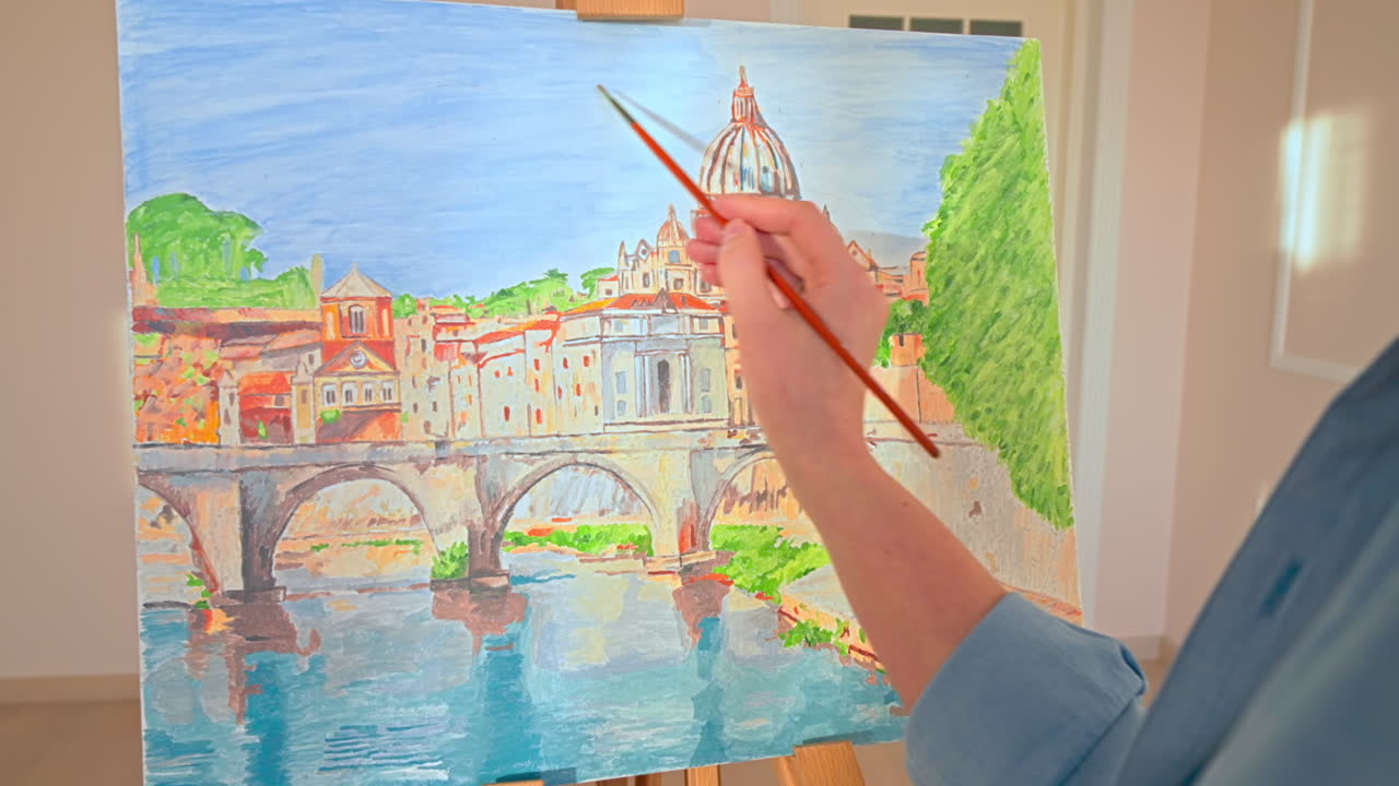 Caucasian woman painting a picture indoors