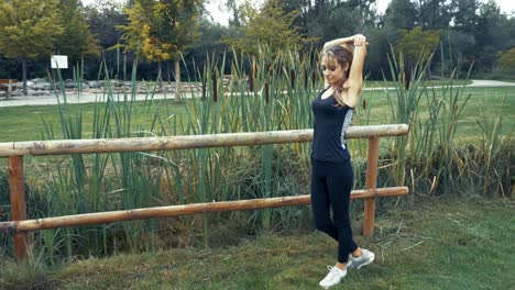 4k-shot-of-young-beautiful-women-doing-exercises-outdoor-in-a-park-at-sunrise