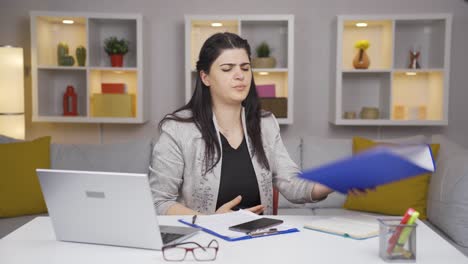 Home-office-worker-woman-looking-at-the-file-angrily.