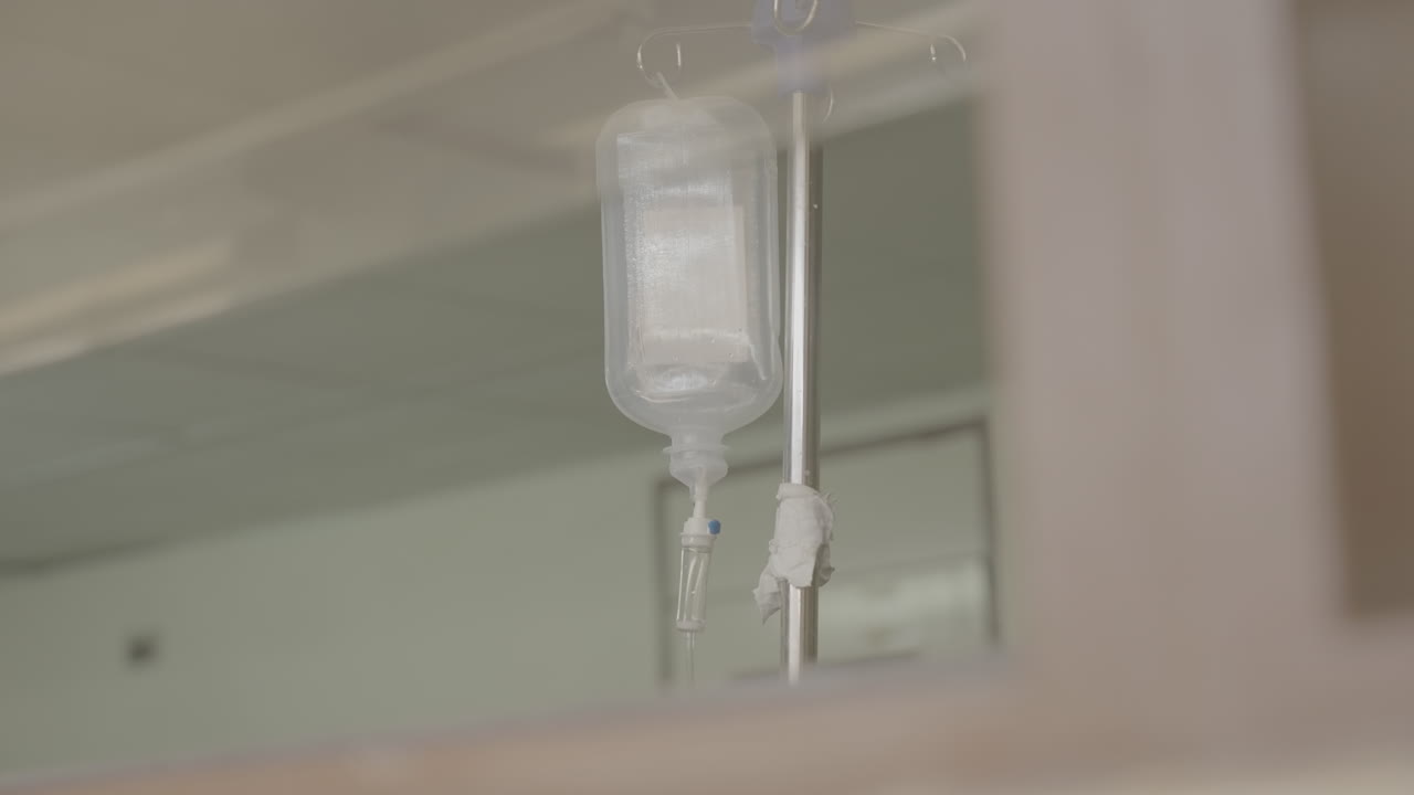 Medium shot of a transparent medical infuse in a hospital in Africa with medicine inside of it LOG