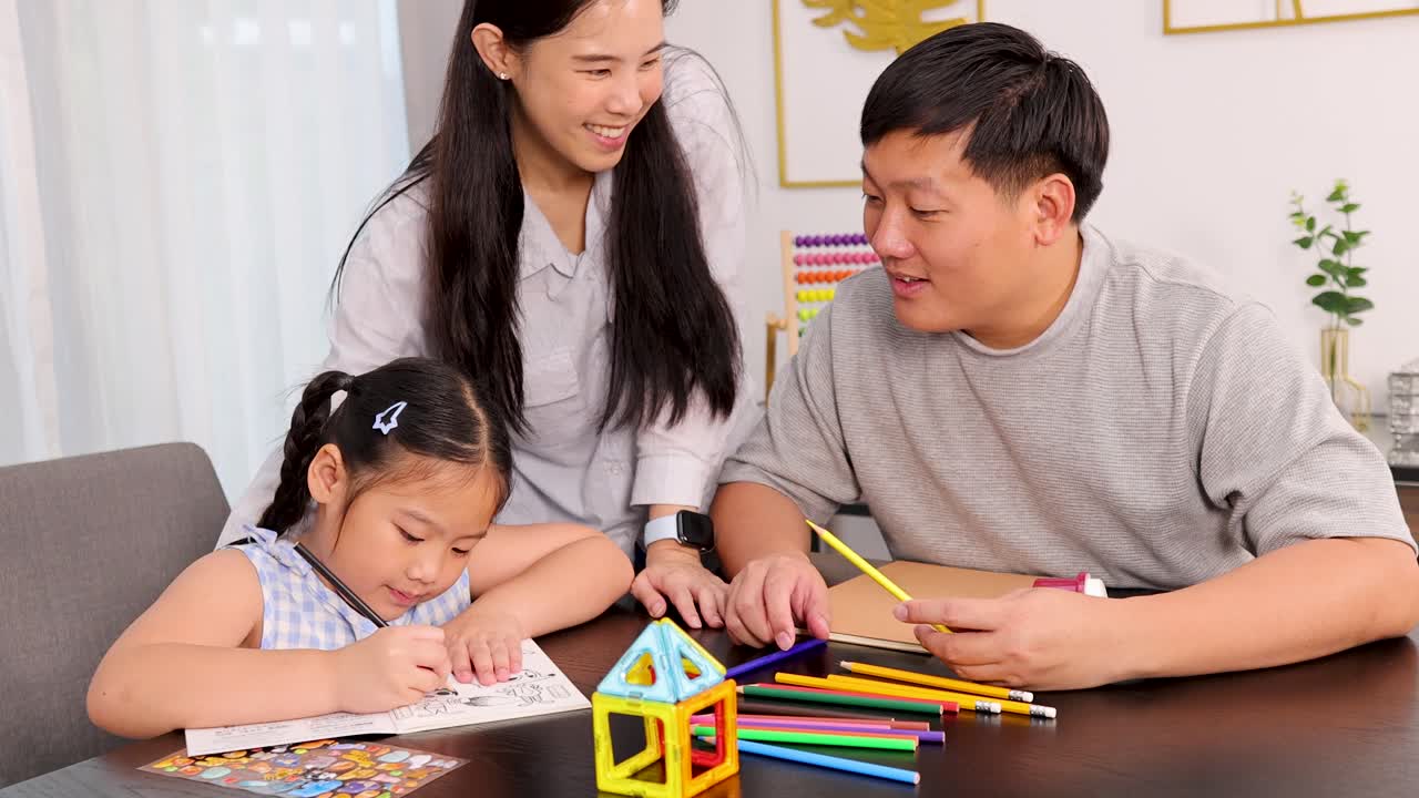 A family enjoys drawing together at a table, fostering creativity and connection in a warm, well-lit home environment