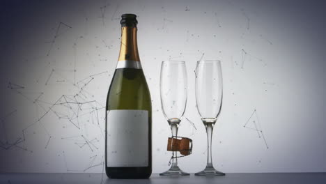 red de conexiones sobre una botella de champán y dos copas de champán contra un fondo gris