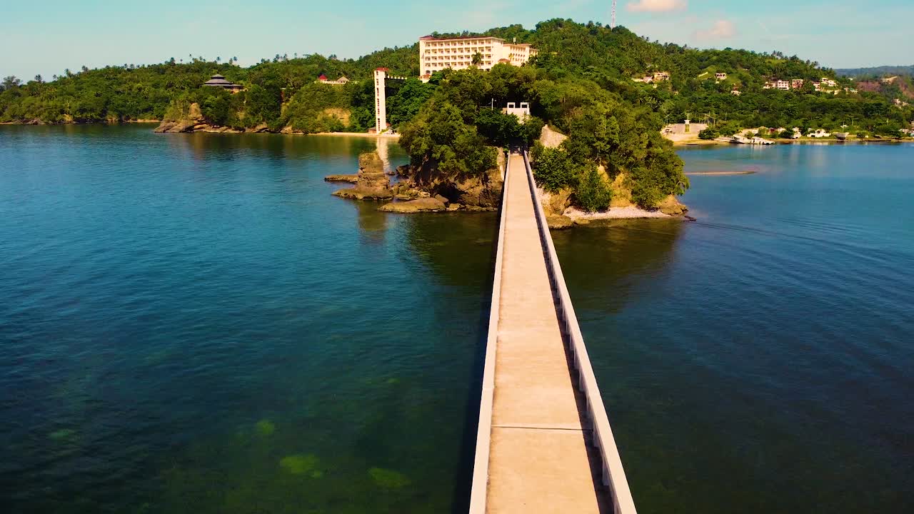 Aerial View of a Bridge Leading to a Tropical Island Resort
