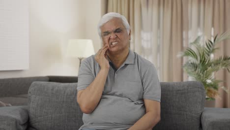 Sick-Indian-old-man-suffering-from-tooth-pain