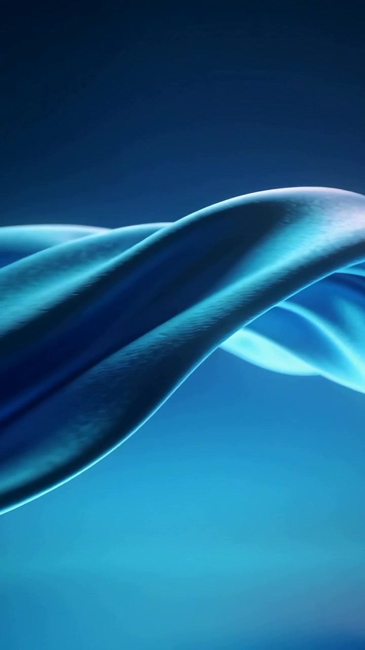 Vertical video: Unfurling blue ribbon across deep teal studio background, driven by gentle motion