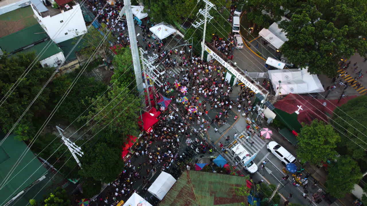 High angle drone shot of crowded streets of Manila, Undas festival in Philippines