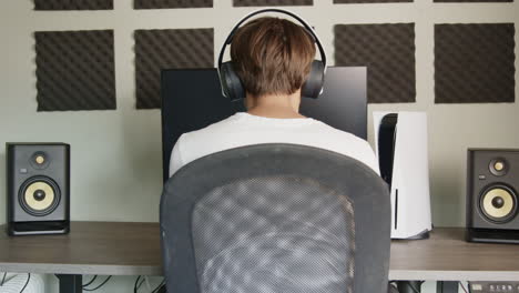 boy gaming on a playstation 5 with a ps5 controller and headset in the afternoon, wide