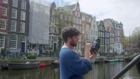 view of an analog film photographer in amsterdam - medium shot