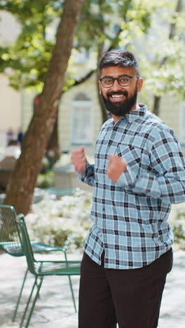 Indian-man-shouting-celebrating-success-winning-goal-achievement-good-victory-news-on-city-street