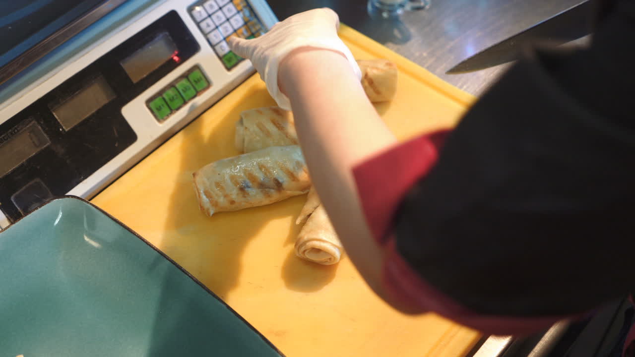 Chef cutting pancakes on a board. Pancakes filled with meat filling