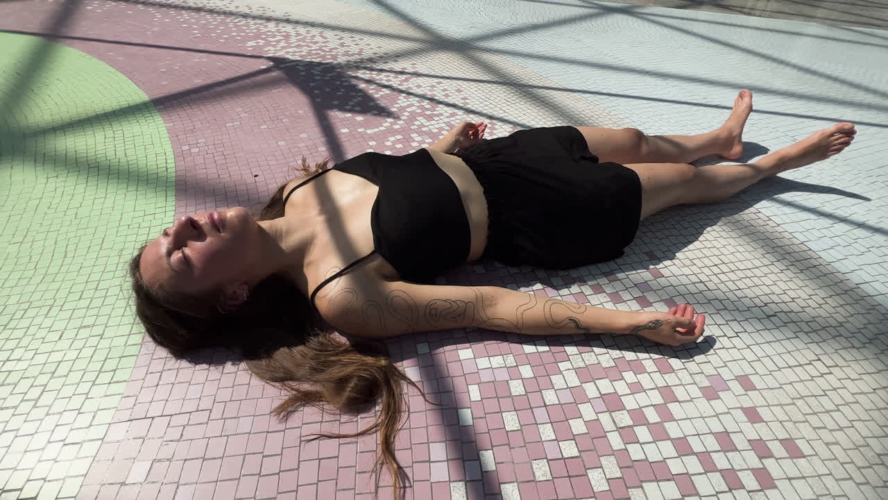 A serene feminine figure lies in still meditation on the sacred temple floor, bathed in soft light, surrounded by etheric geometry—an otherworldly moment of cosmic peace and inner awakening.