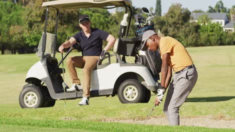 video of diverse male friends playing golf on golf field