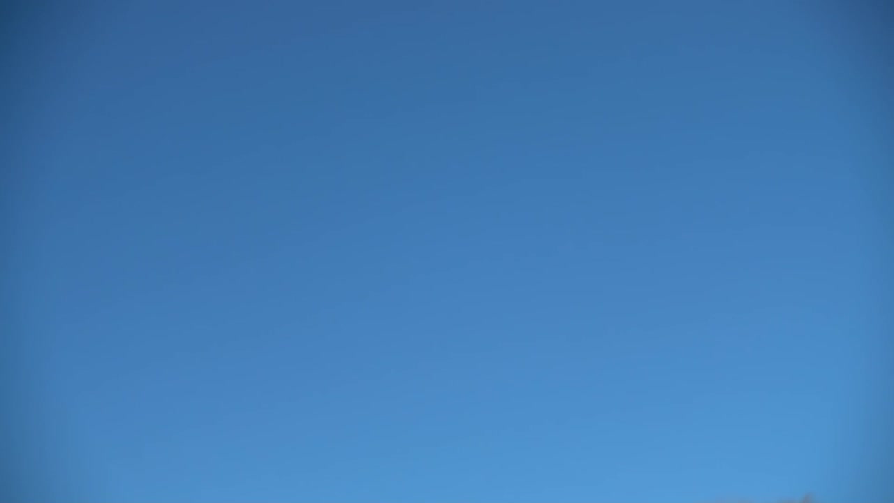Soap bubbles against the background of the sky. Slow motion