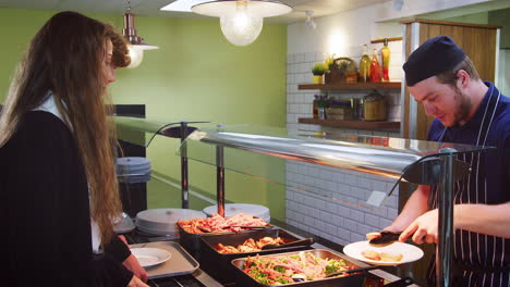 teenage students being served meal in school canteen