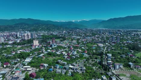 Aerial-view-of-a-suburban-cityscape-with-residential-buildings,-parks,-and-green-spaces,-highlighting-the-organized-urban-planning-and-community-living