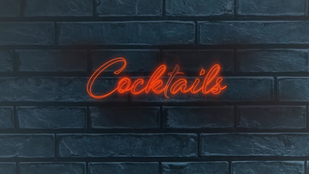 texto de cóctel naranja de neón contra una pared de ladrillo gris en el fondo