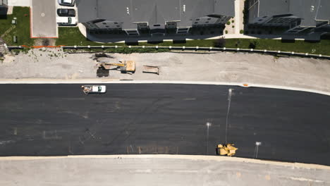 suburban utah roadwork aerial view looking down over construction equipment road development site