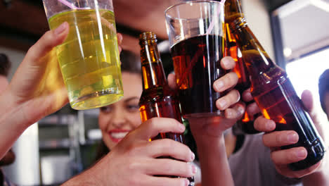 friends toasting drinks together in restaurant