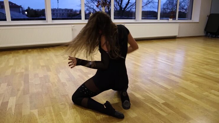 Professional and passionate female dancer dances on the dance floor slow motion
