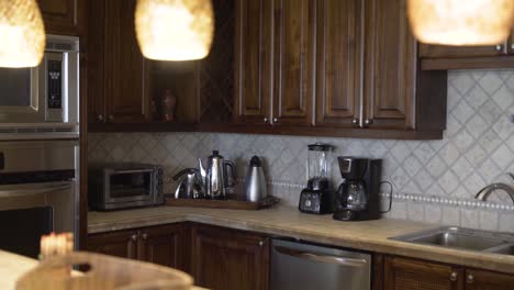 kitchen with wooden furniture, faucet, oven, faucet and light fixtures