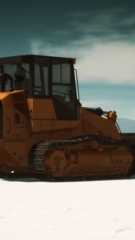 orange bulldozer on snow