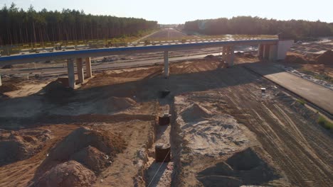 aerial close shot of a viaduct over the new highway construction site