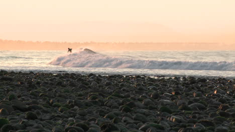 Pan-of-surfer-catching-a-wave-at-Surfers-Point-in-Ventura-California