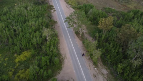 Group-of-people-walking-on-rural-road,-Mar-de-las-Pampas-in-Argentina