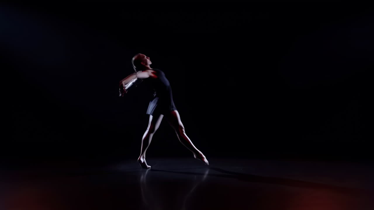 Graceful Female Dancer Performing Contemporary Choreography on Dark Stage