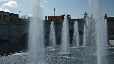 Una-Fuente-De-Chorros-De-Agua-Cerca-De-Un-Puente-En-La-Ciudad