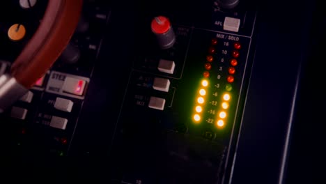 close-up of headphones on professional audio equipment control panel