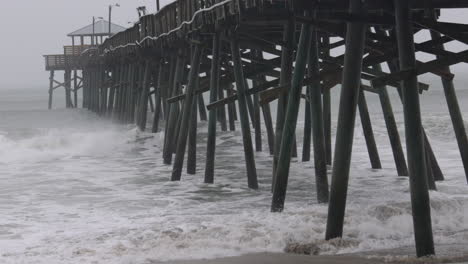 hurricane waves crashing into pier in slow motion