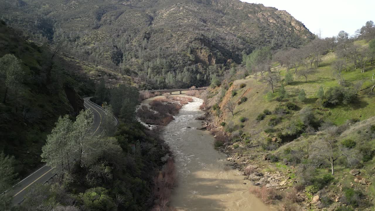The aerial view of Cache Creek in Rumsey reveals a peaceful waterway surrounded by rolling hills and greenery.
