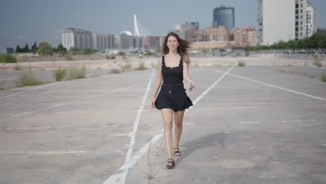 woman walking in a city parking lot