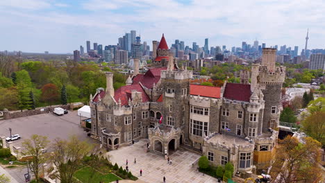 drone video flying around casa loma in toronto with cn tower in view