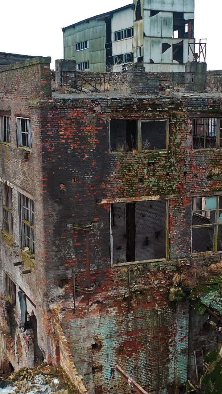 Abandoned industrial building. Ruins of an old factory. Aerial view Vertical video