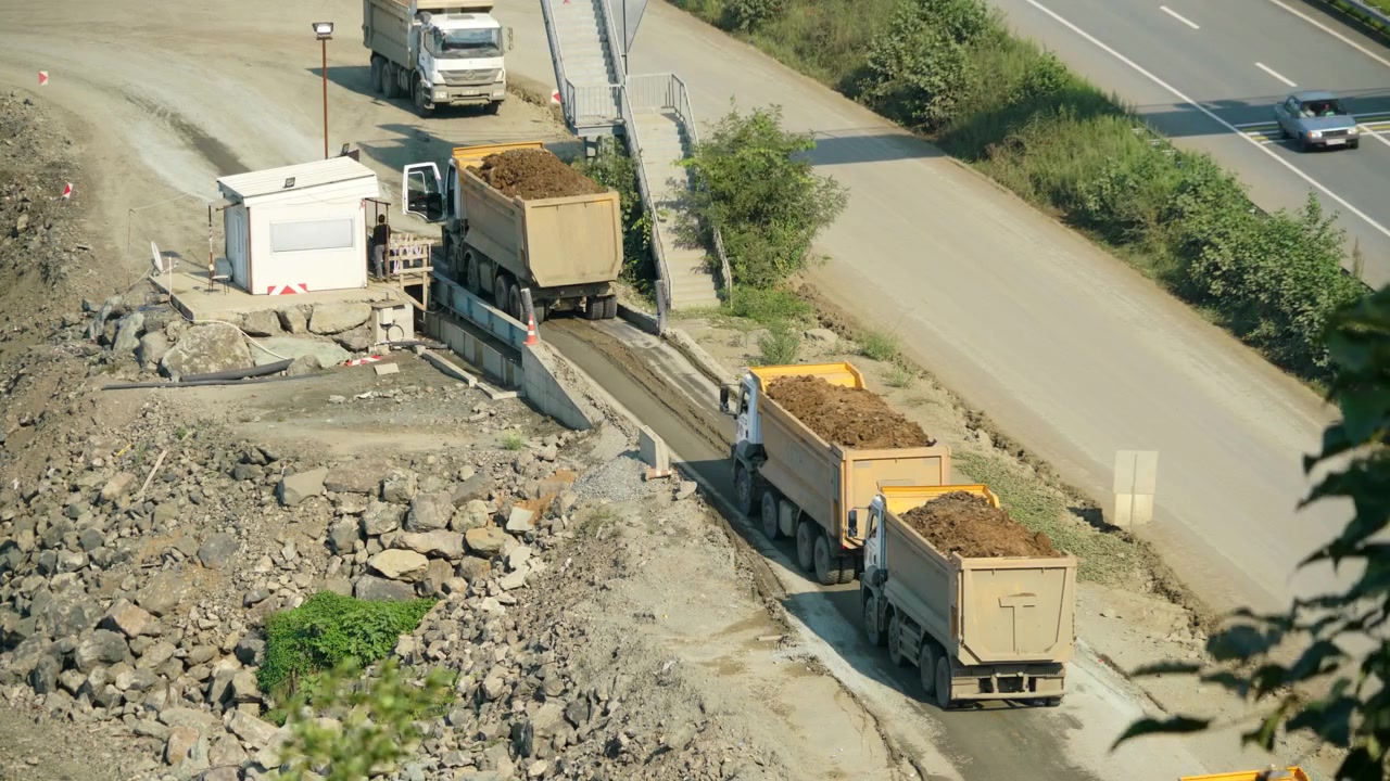 Dump Trucks Transporting Soil at a Construction Site