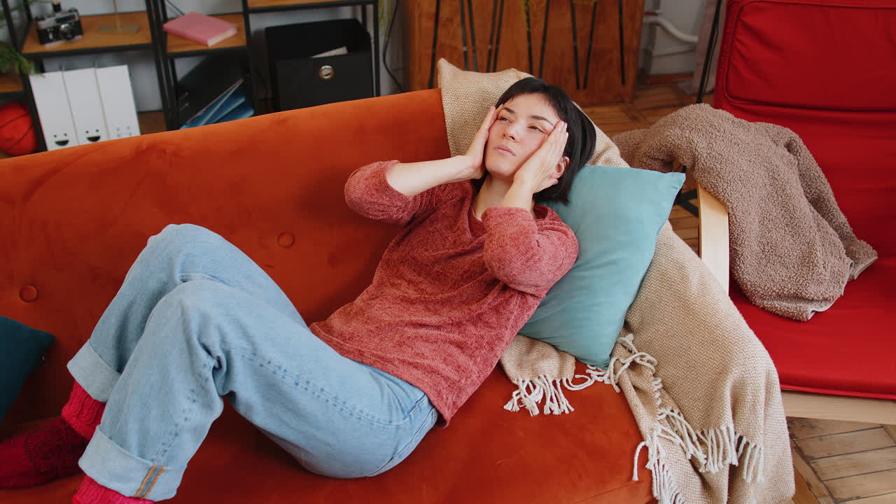 Upset woman rubbing temples to cure headache problem suffering from tension migraine stress pain