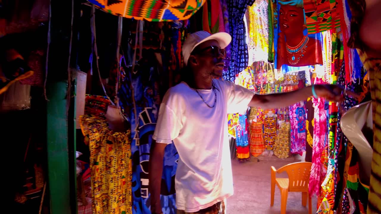 Walking in middle of african clothing at a shop in the Serekunda market, Gambia