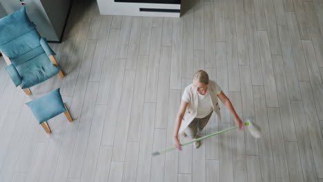 woman sweeping a floor