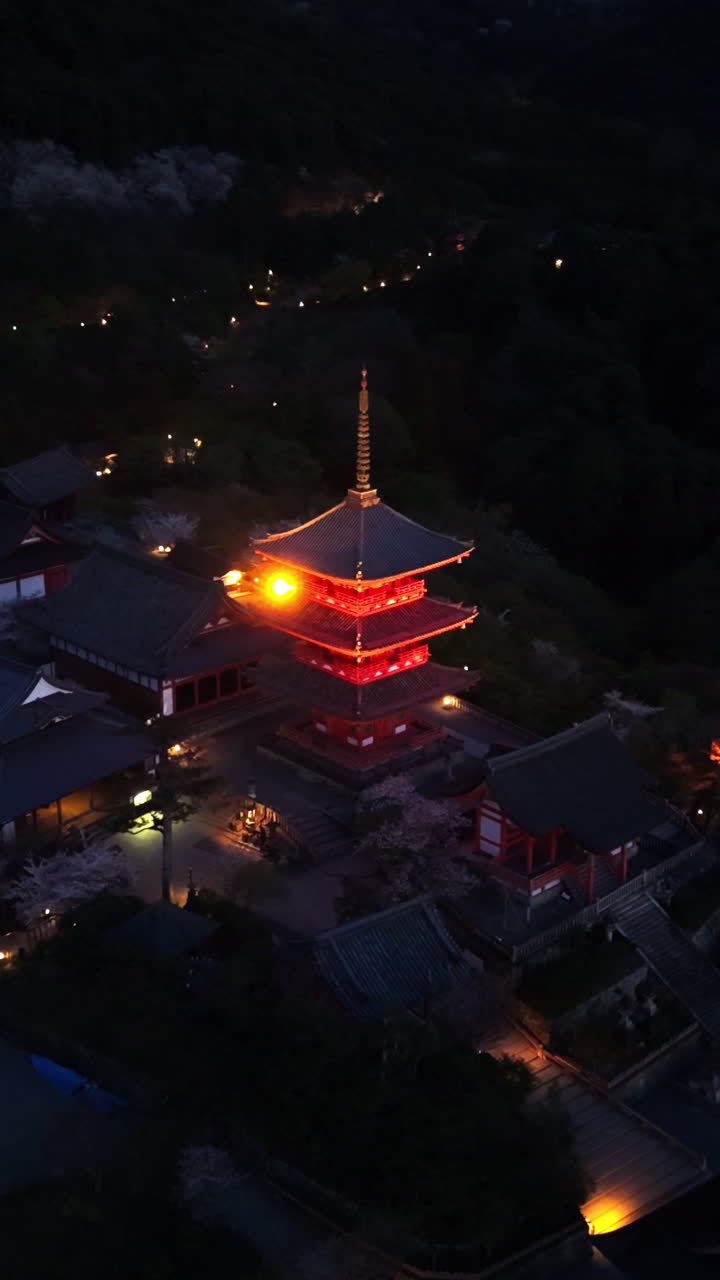 Aerial drone view of the illuminated Kiyomizu-dera temple in the evening in Kyoto, Japan