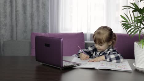 girl learning online lessons using digital laptop computer. distance education