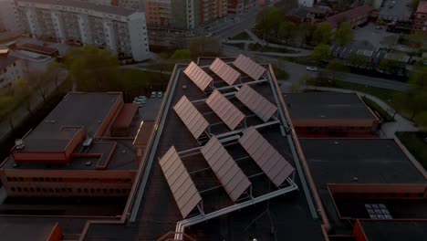 solar panels atop building. drone orbital view