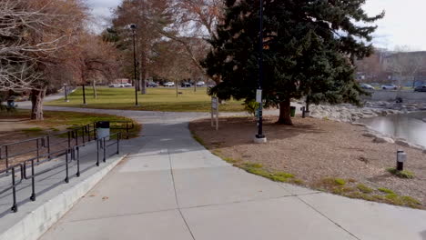 first person view down walkway in park on a winter day in reno, nevada