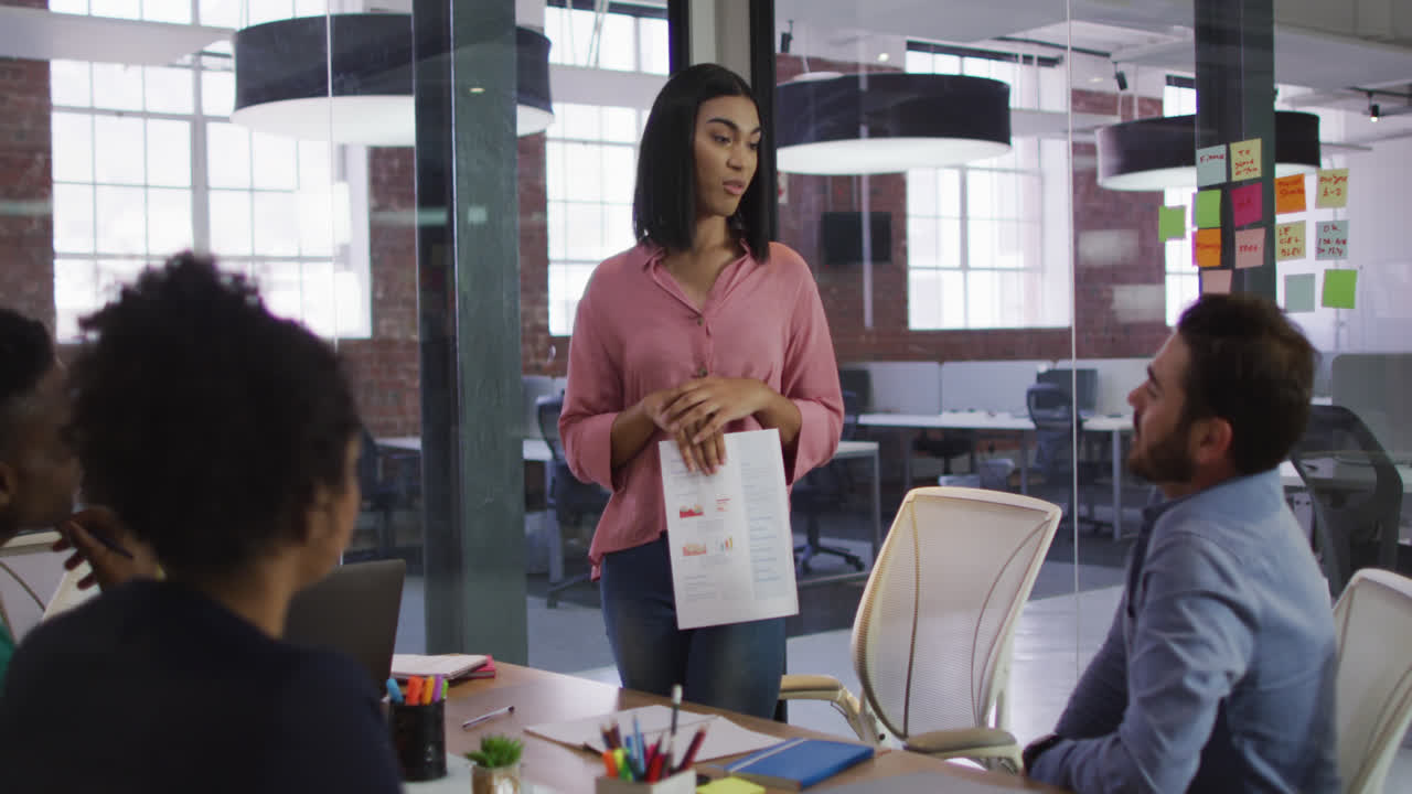 Mixed race businesswoman having a meeting with colleagues in meeting room