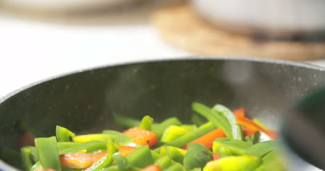 mixing fresh vegetables on pan 2