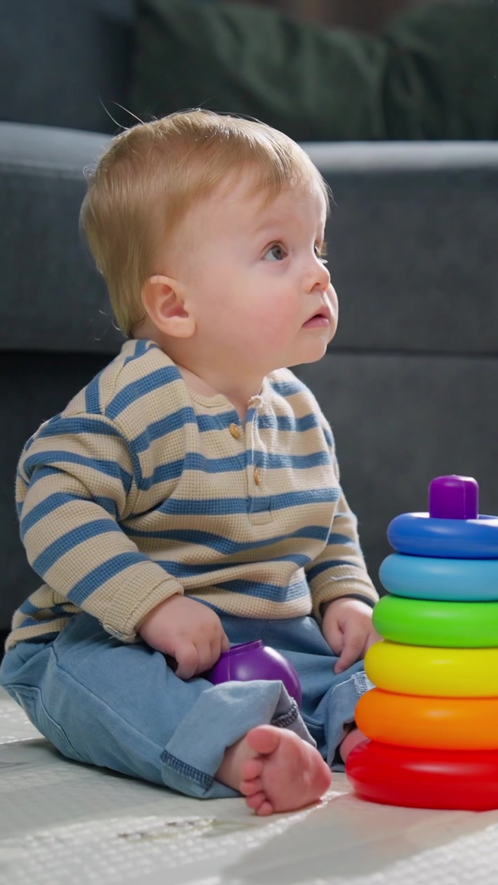 Cute Baby Boy Playing with Colorful Stacking Rings Toy