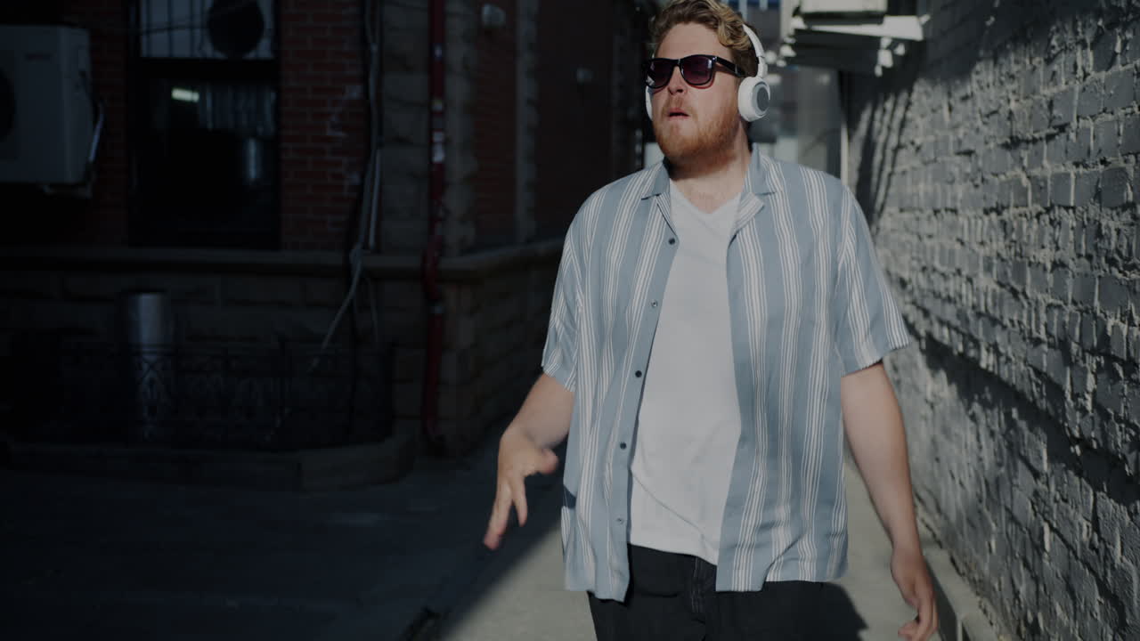Man Dancing in an Alley with Headphones